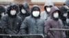 RUSSIA -- Migrants labors stand in line at a migration control center to ask for extension their work permits in Russia during the COVID-19 coronavirus pandemic, in St. Petersburg, April 2, 2020