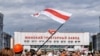 BELARUS – Protest in Belarus nearby Minsk tractor plant, flag of protesters over the factory and workers coming from their shifts, the beginning of a strike. Minsk, August 18, 2020